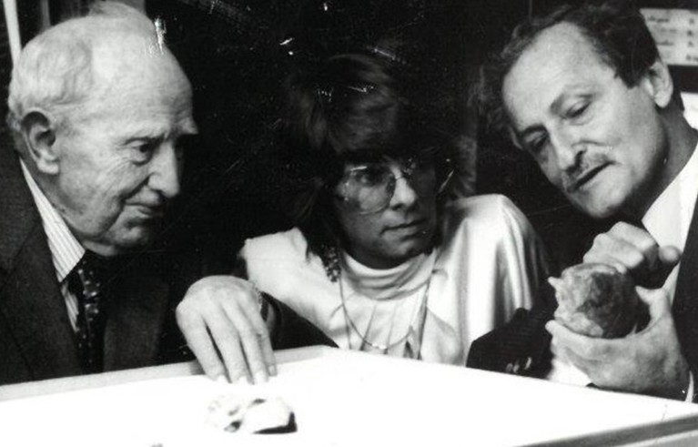 Raymond Dart, Dean Falk and Phillip Tobias looking at is the Taung endocast