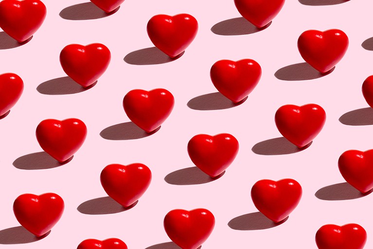 A red love hearts pattern on a pink background.