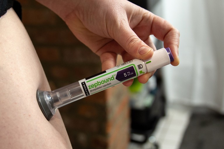 Close up view of a person using an Eli Lilly & Co. Zepbound injection pen