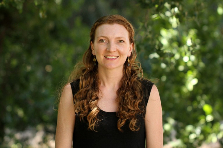 Portrait of Summer Praetorius standing outside with trees in the background