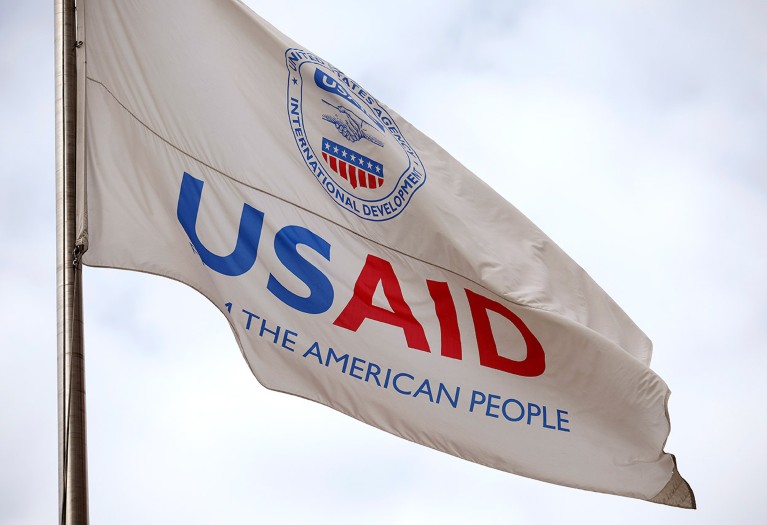 A flag displaying the logo for U.S. Agency for International Development (USAID) outside its headquarters in Washington, DC.