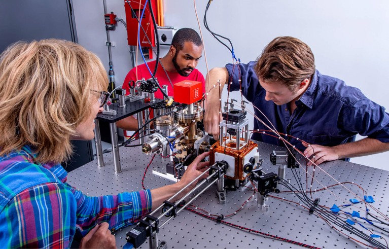 Researchers work on the Aquila magneto-optical trap in QuEra’s facilities.