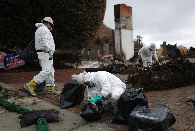 Environmental Protection Agency (EPA) contractors remove hazardous waste from a fire-destroyed home in Altadena, California.