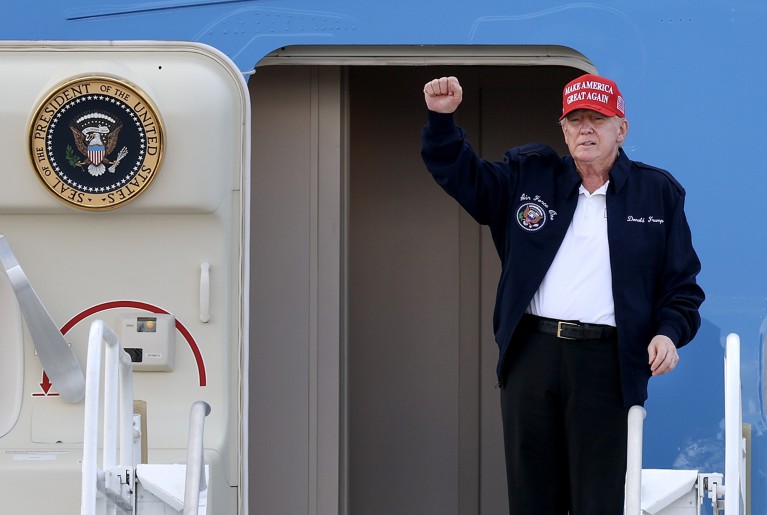 U.S. President Donald Trump gestures as he departs Air Force One.