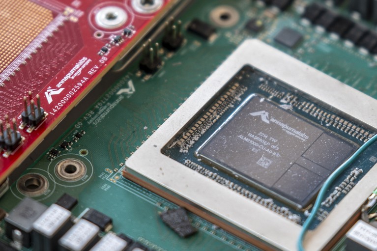 A close-up shot of an artificial intelligence chip sitting on a green motherboard