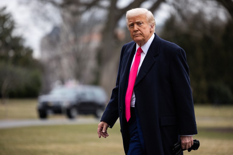 U.S. President Donald Trump walks to the White House residence from his helicopter.