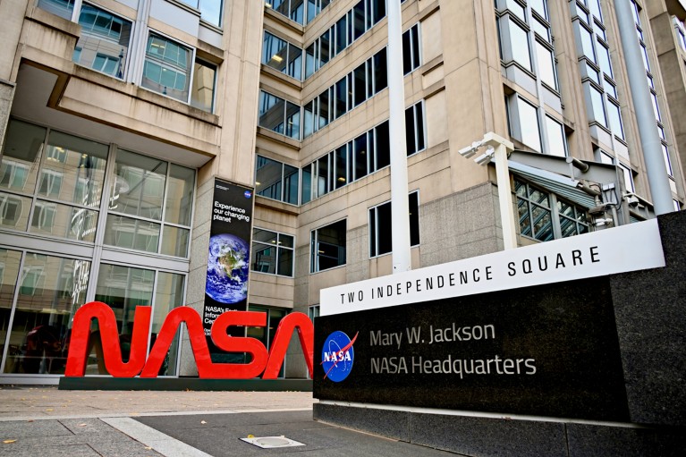 The NASA logo in large red 3D letters outside the NASA Headquarters building