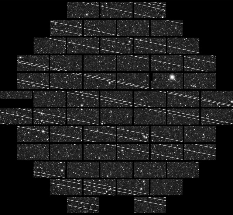 Black and white long exposure photo of satellites streaks made of separate photos with some gaps in it.