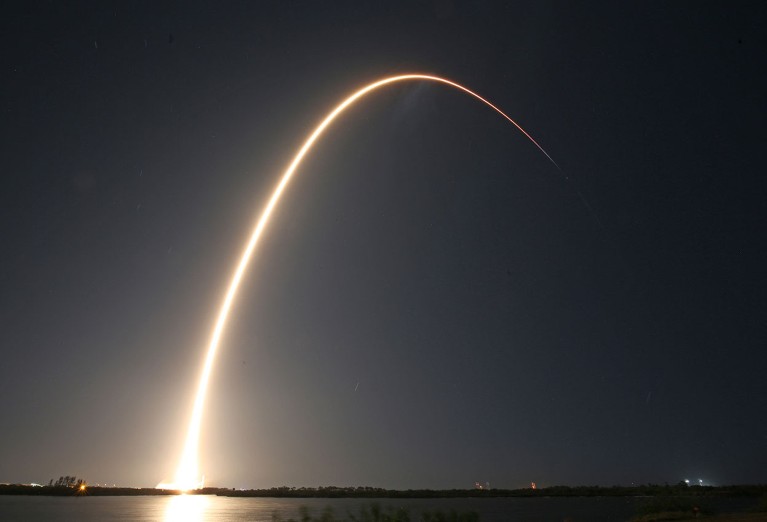 A SpaceX Falcon 9 rocket streaks into orbit after lifting off from the Kennedy Space Center in Florida.