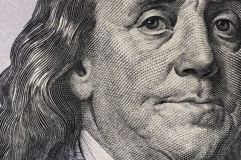 Extreme close-up on the etching-style portrait of Benjamin Franklin that appears on the US one-hundred-dollar bill