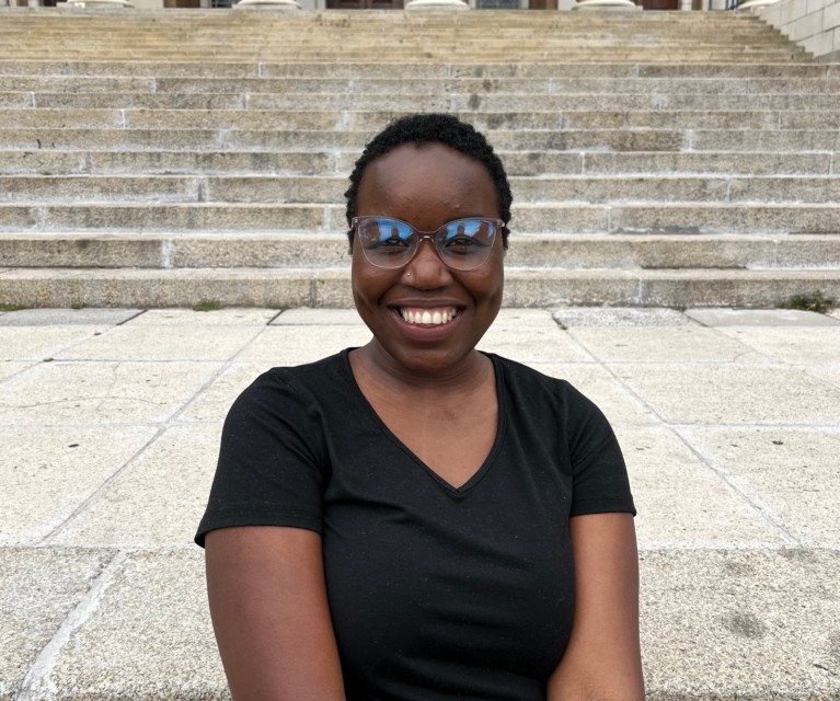 Nxalati Mkhombo sitting in front of university steps.