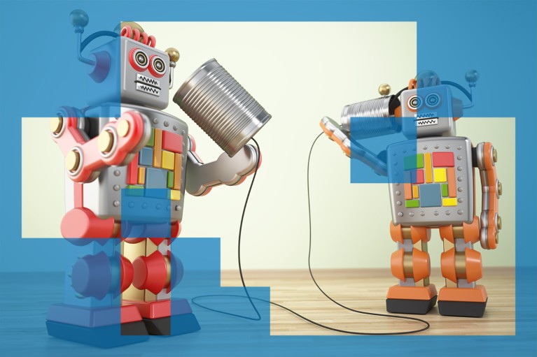 Two toy robots posed as though communicating with two tin cans linked with a piece of string.