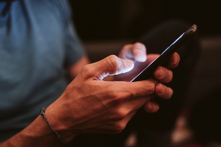 Close up on a pair of male hands holding a smart phone