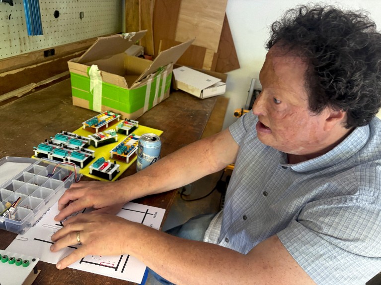 Josh Miele demonstrating using a tactile map in his workshop.