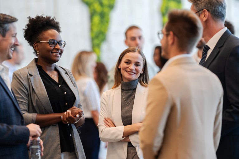 A diverse group of people chatting at a business conference.