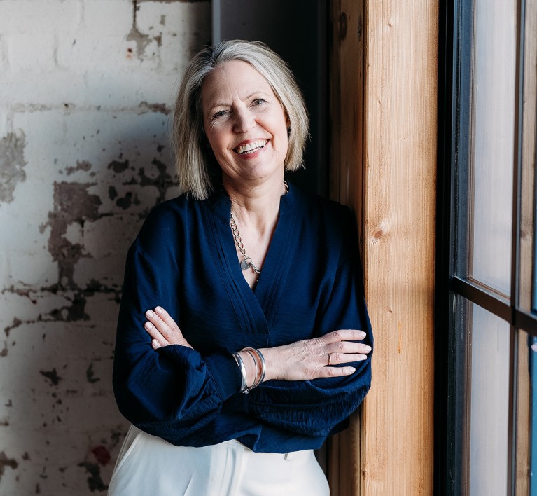 Portrait of Caroline Dunne with her arms folded.