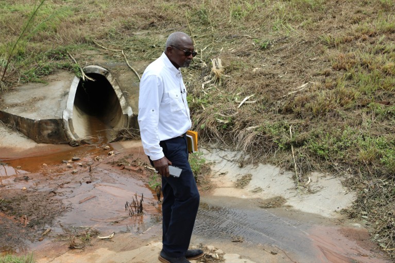 Robert Bullard stands next to a drainage pipe