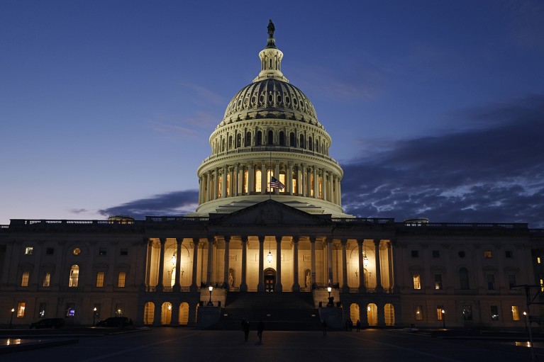 The U.S. Capitol building is illuminated at dusk.