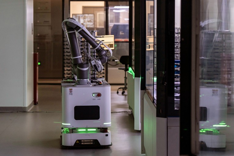 A robot that looks like a box with a robotic arm operates inside a lab in China.
