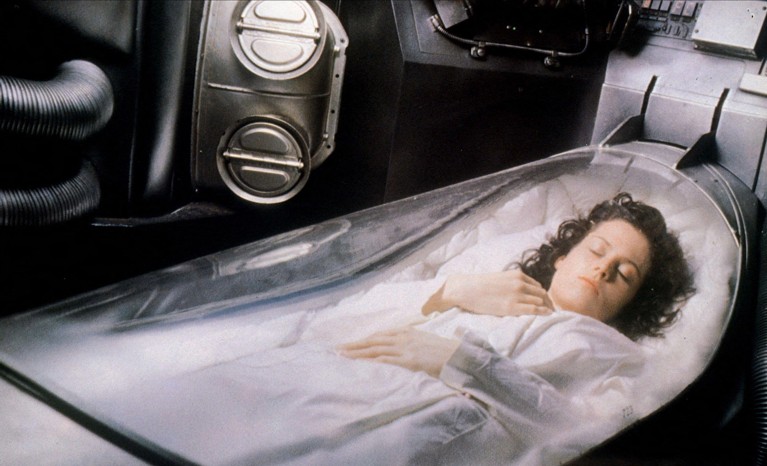 A still of Sigourney Weaver in a scene from 1979 science fiction film Alien where her character is in a cryosleep pod.