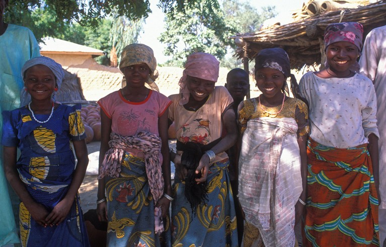 A group of five smiling Nigerian girls pose together for a photograph in northern Nigeria.