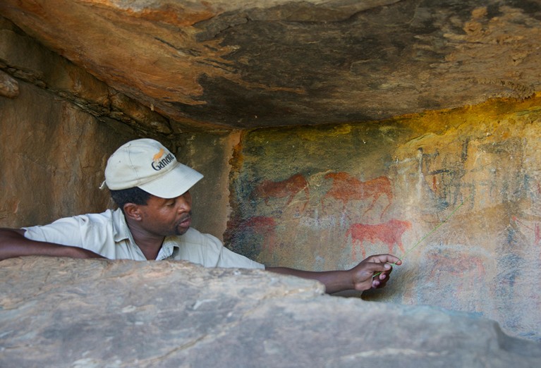 Guide showing San rock art Ganora Guest Farm near Nieu Bethesda Karoo Eastern Cape South Africa.