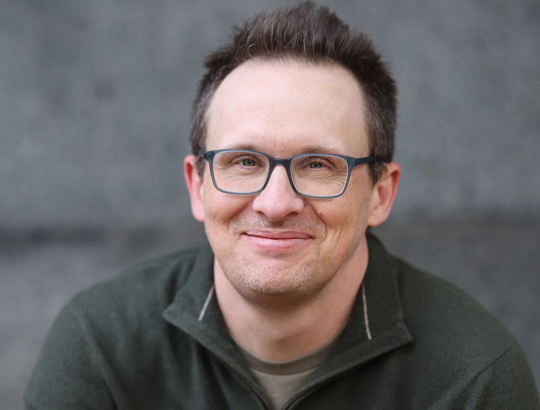 Portrait of Bennett Foddy smiling.