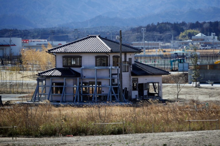 The remains of a damaged house, standing alone in waste ground, following the tsunami triggered by the Great East Japan Earthquake.