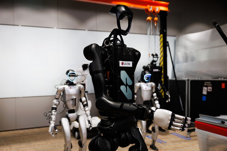 Several humanoid robots standing in a research laboratory at the LG CNS Co. headquarters in Seoul.