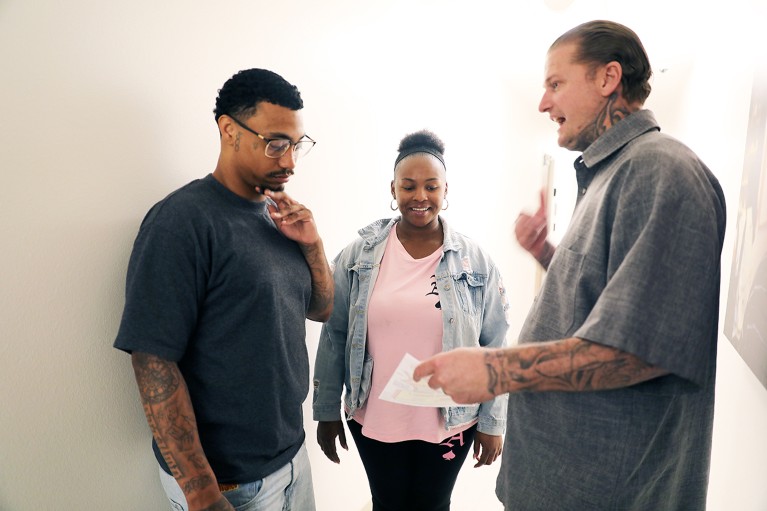 Ryan Rising speaking with two young people.