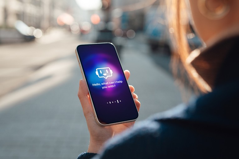 An over the shoulder view of a woman walking down a street holding a smartphone in her hand. The screen shows an AI chatbot.