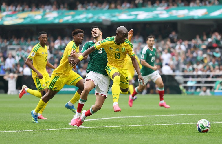 Raúl Jiménez of Mexico is challenged by South Africa’s Nkosinathi Sibisi during their 2026 World Cup Group A match at Mexico City Stadium.