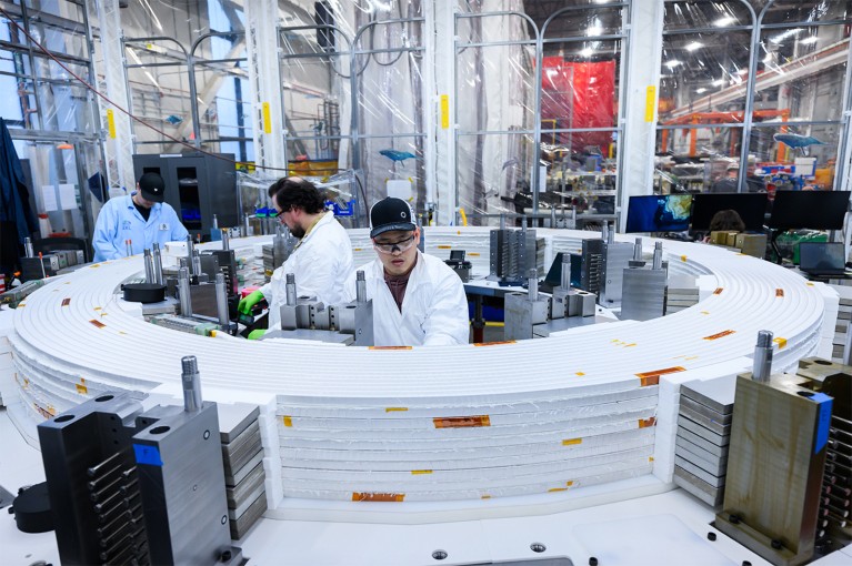 Inside view showing workers in the CFS Magnet Factory.