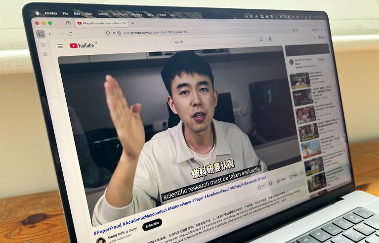 A MacBook computer on a table displays a YouTube video from science sleuth Student Geng.