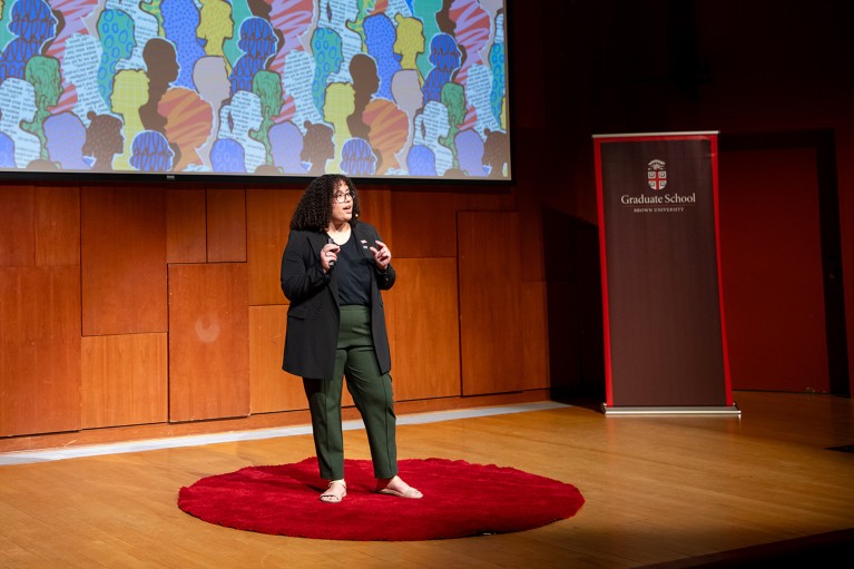 Melanie Ortiz Alvarez de la Campa stands on stage to give a presentation at Brown University.