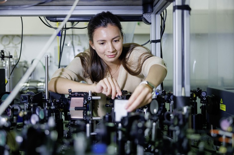 Tatiana Uaman Svetikova leans forward to make adjustments to the experiment she is running at the free-electron-laser facility at the Helmholtz-Zentrum Dresden-Rossendorf.