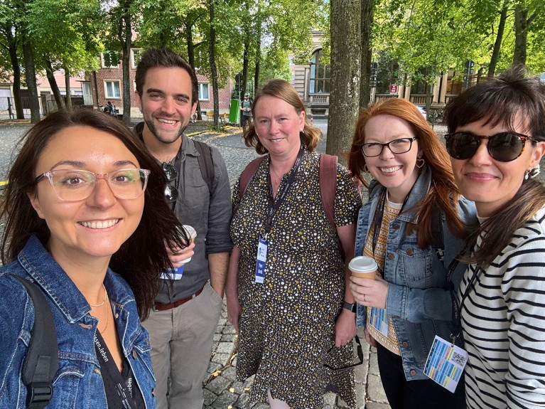 Professor Madeleine Pownall poses for a photo with four academic friends.
