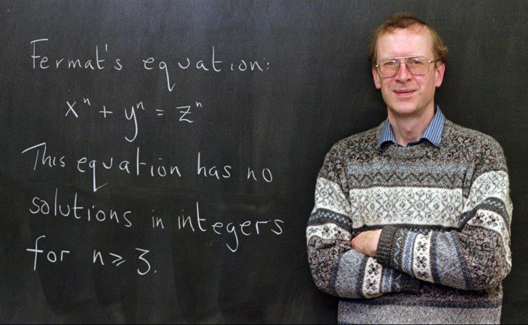 Andrew John Wiles poses next to Fermat's Last Theorem, written on a chalkboard in his Princeton university office in 1998.