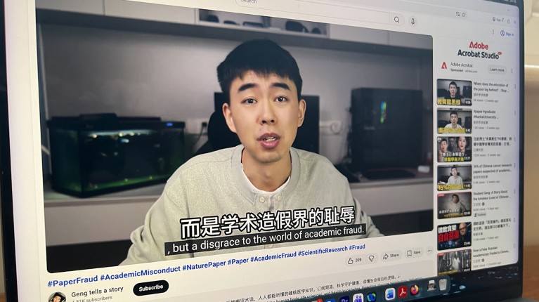A MacBook computer on a table displays a YouTube video from science sleuth Student Geng.
