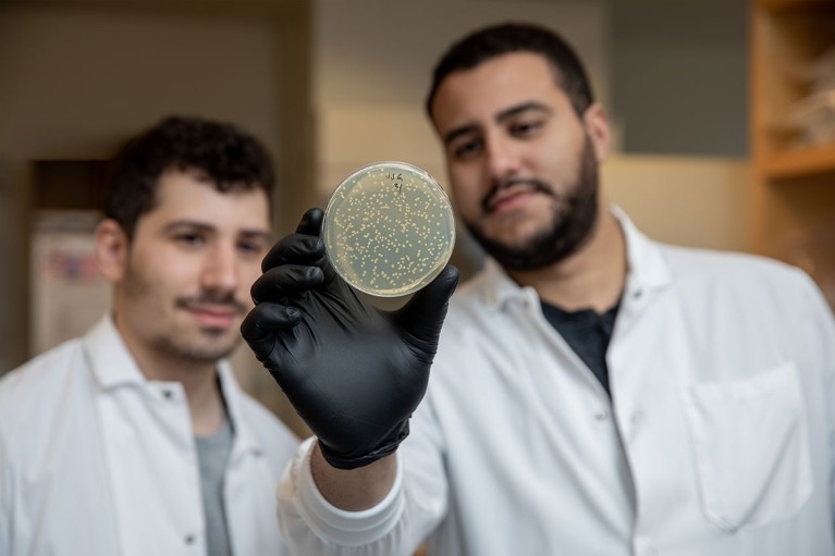 Jonathan Gootenberg and Omar Abudayyeh looking at a Petri dish.