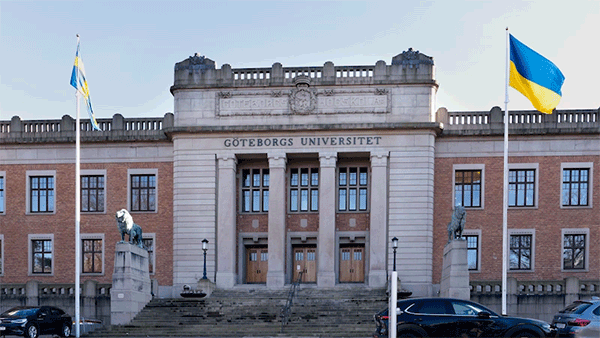 Animated transition between the original photograph of the exterior of the University of Gothenburg and the digitally manipulated photo of a building identified as the European Academy of Engineering.