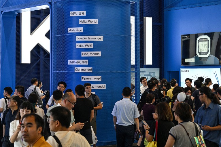 Multiple people visit the Moonshot AI exhibition stand featuring the Kimi K3 mode during the World Artificial Intelligence Conference in China.