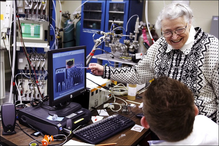 Mildred Dresselhaus is seen in a laboratory speaking with a young student who is working at a PC.