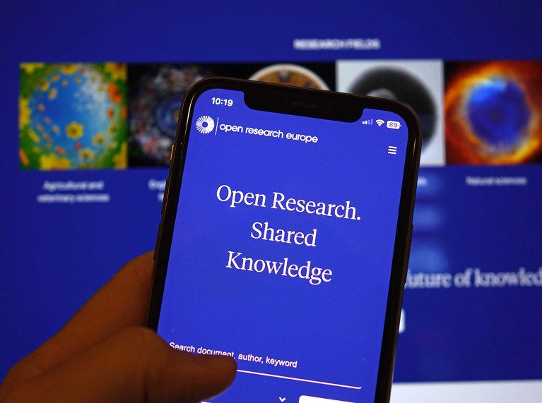 Smartphone with the Open Research Europe website open on the screen and in the background is the webpage open on a laptop screen.