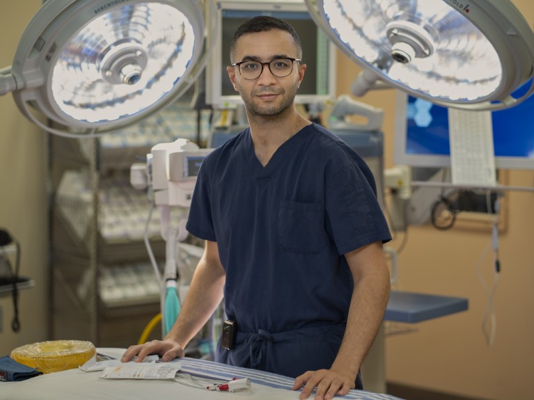 Ibrahim stands by a table in his operating theatre.