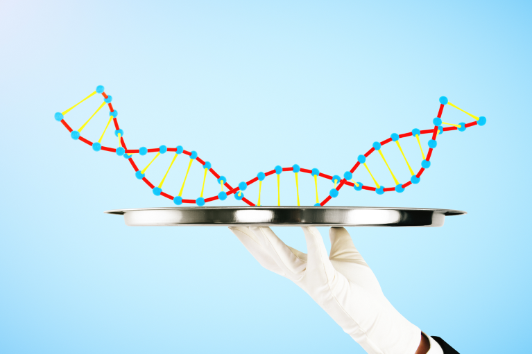 Hand holding tray with DNA on blue background