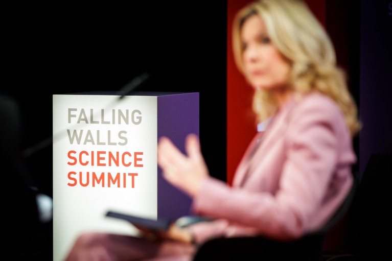 A presenter on stage at the Falling Walls Science Summit