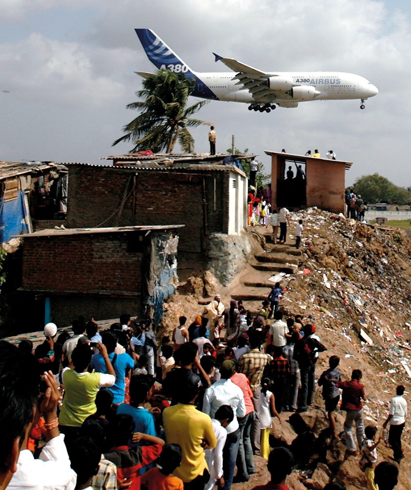 People watch plane land at Mumbai airport