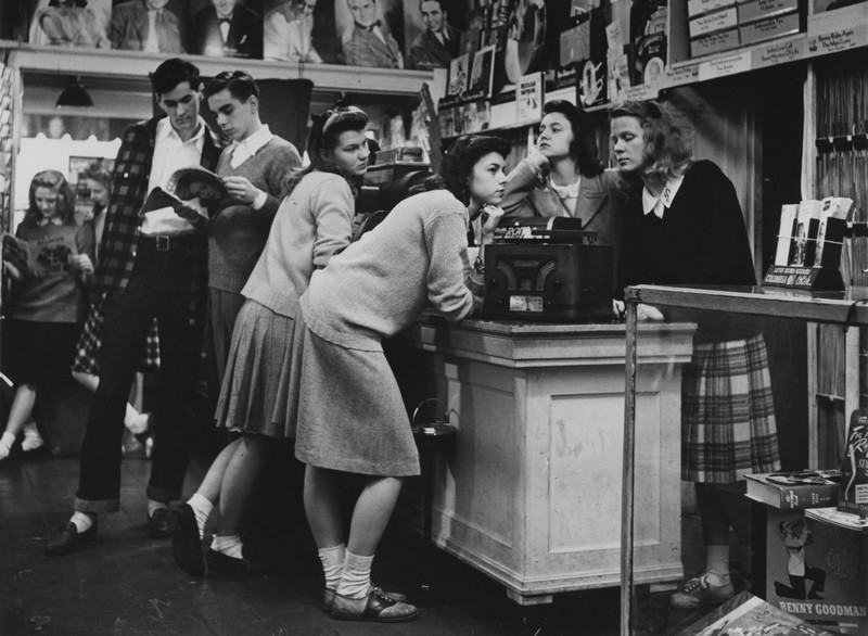 1940s teens listen to records in a record store