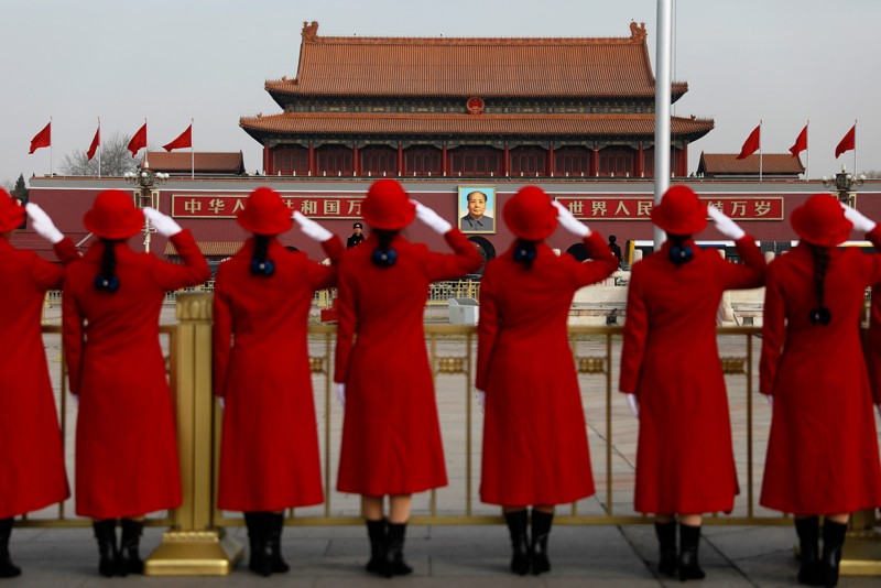 Chinese stewardesses salute in Tiananmen Square